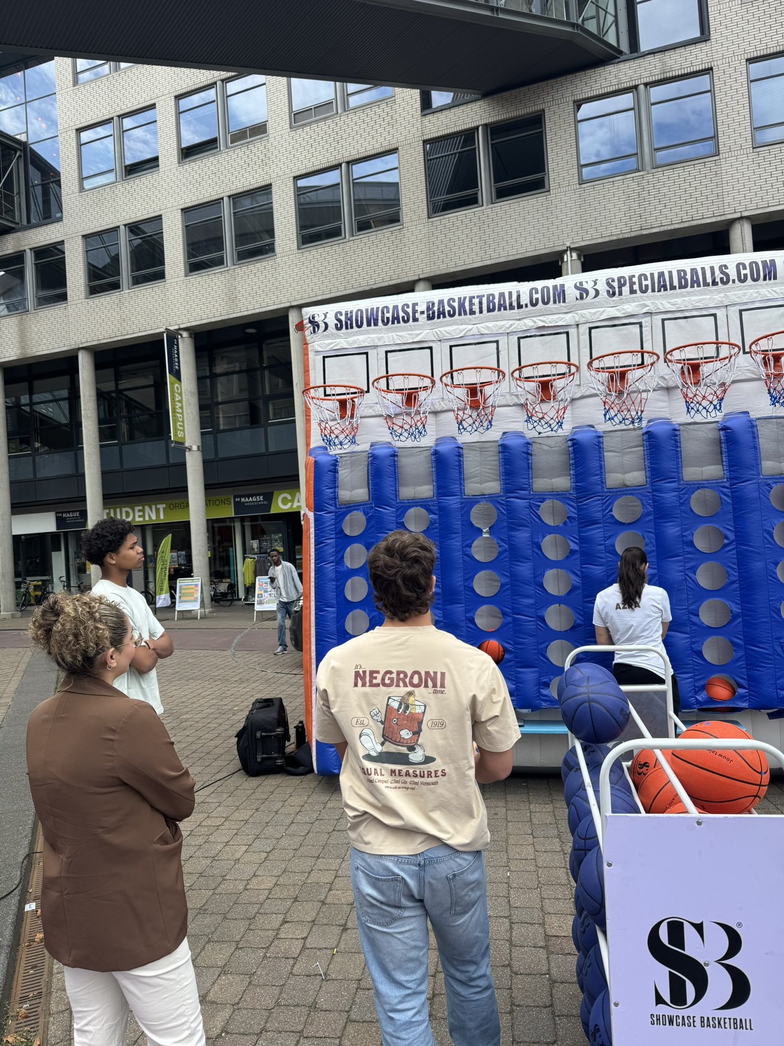 Studenten kijken toe bij levensgroot vier op een rij op De Haagse Hogeschool