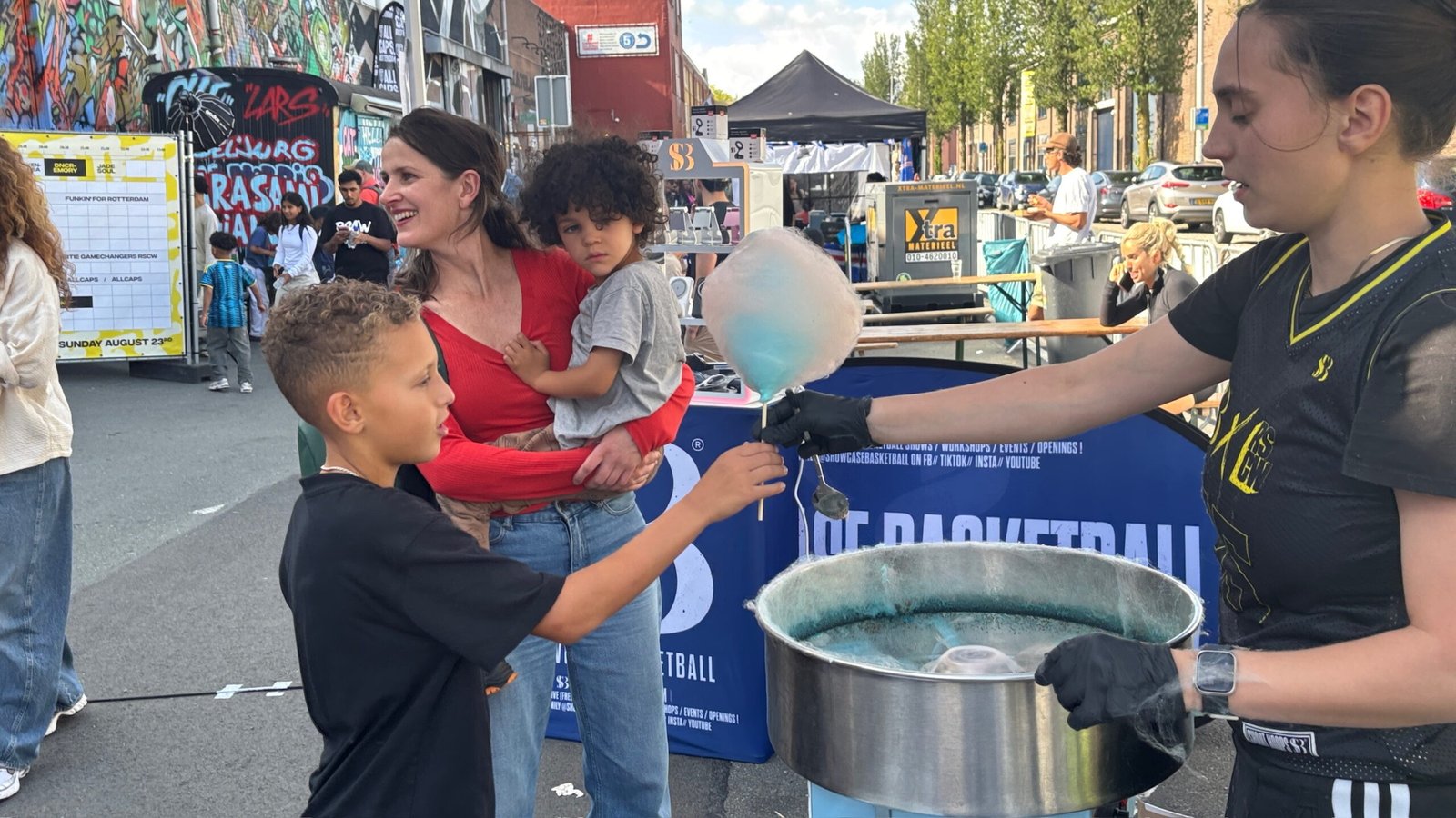 Azra draait een suikerspin bij de stand van Showcase Basketball