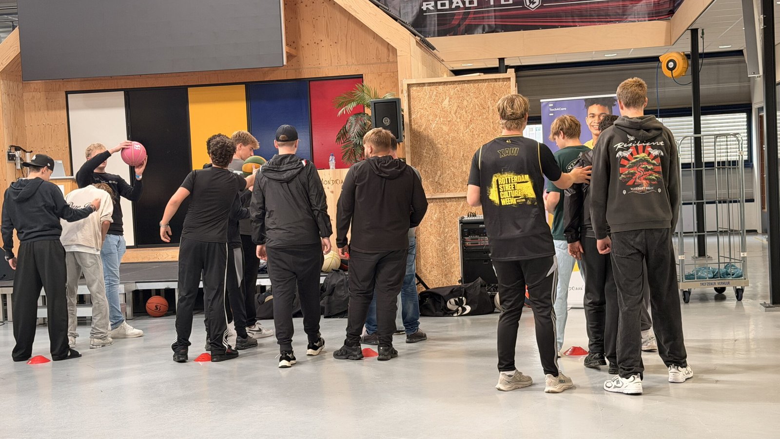 Teamlid doet een freestyle truc voor een grote groep leerlingen