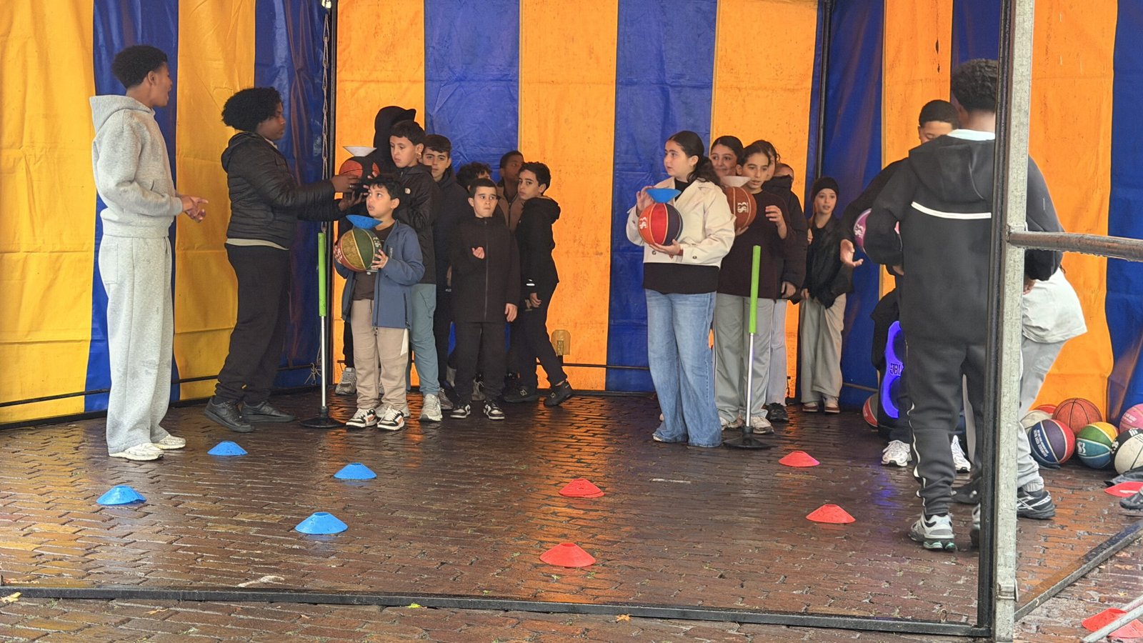 Kinderen van groep 8 met basketballen bij de workshop van Showcase Basketball